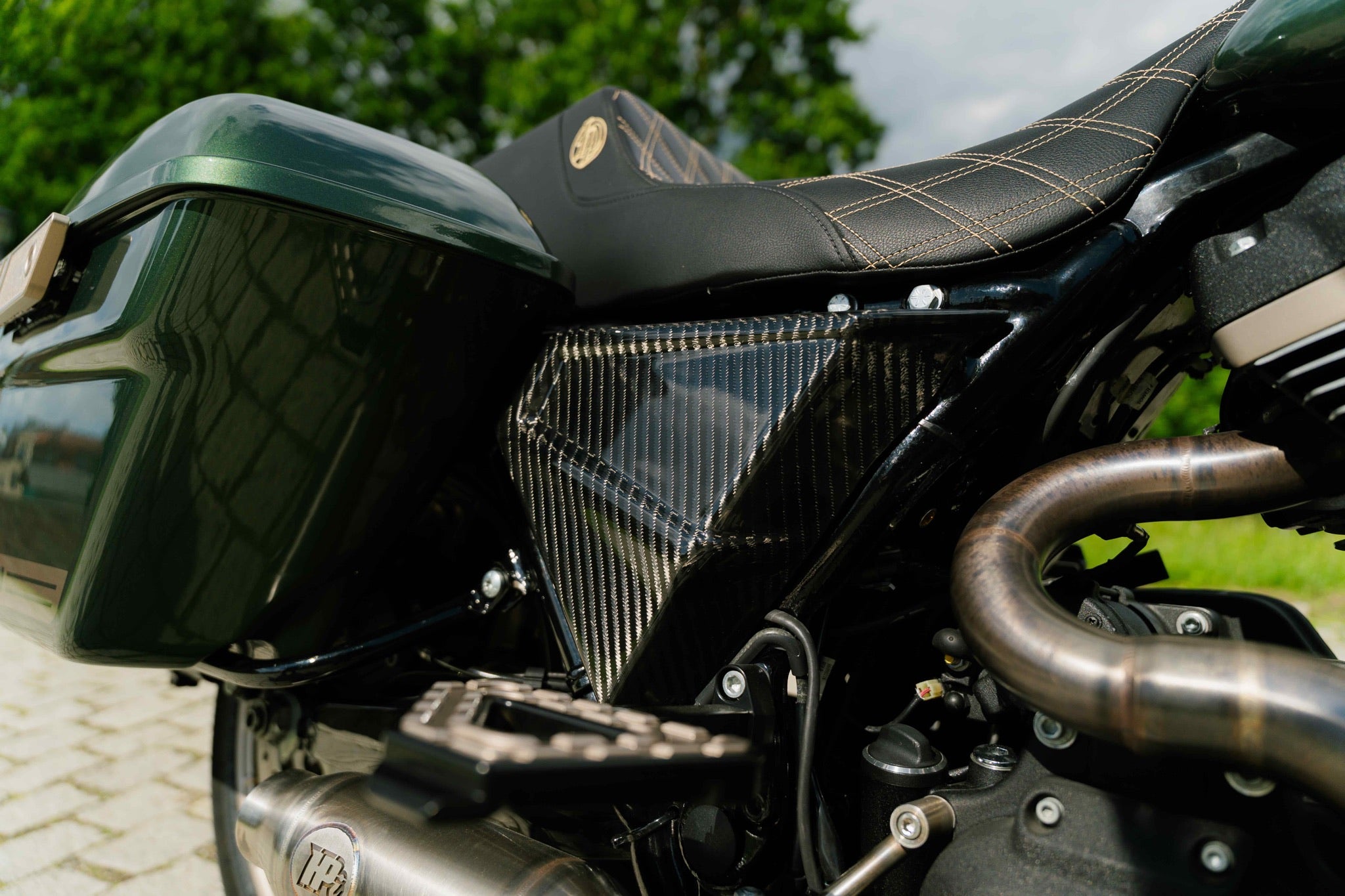 Close up shot of FXR style carbon fiber side covers for Harley Davidson
