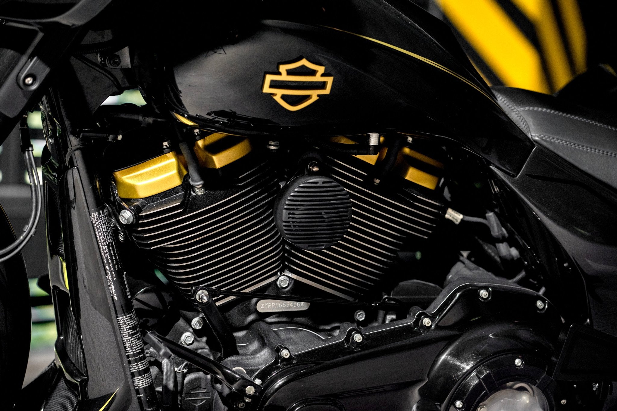 A custom horn cover made by Tommy&Sons, mounted on a Harley Davidson street glide 2021 and photographed from upclose. The horn cover has a unique design with cut throughs, having similar lines and patern to the cylinder walls.