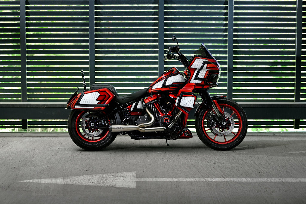 Harley Davidson Low Rider S FXLRS pictured from the side. The motorcycle is equiped with custom clubstyle saddlebags, fairing, floorboards and risers.