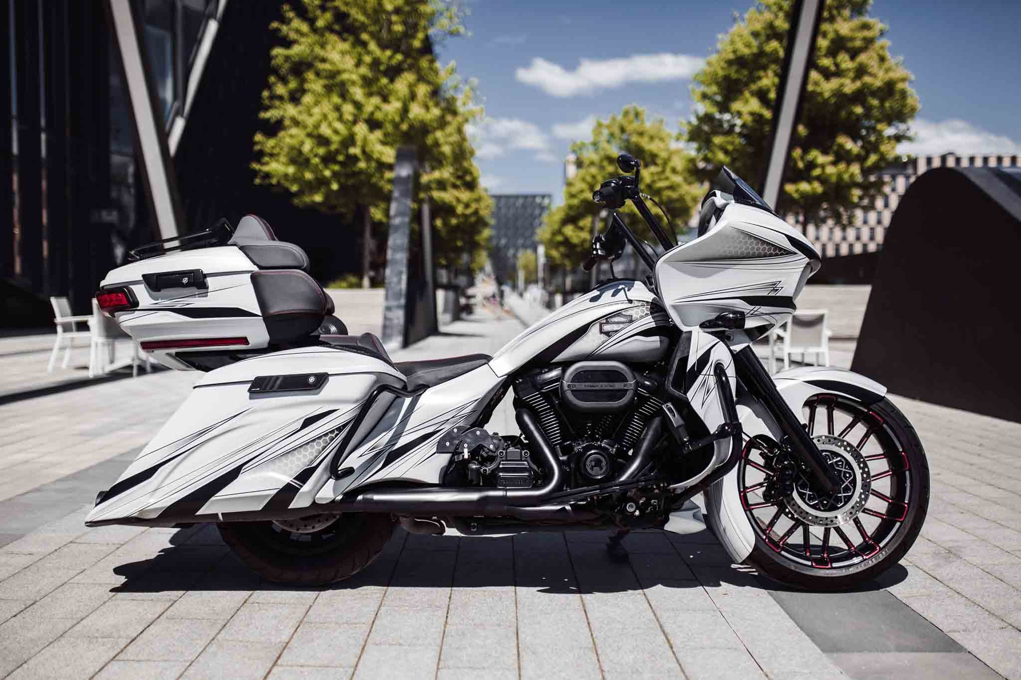 Custom Harley Davidson Road Glide with white Magnus body kit constructed by Tommy&Sons, photographed from the right side. The motorcycle is customized into a bagger style Harley Davidson with a 21x5.5" fat front wheel.