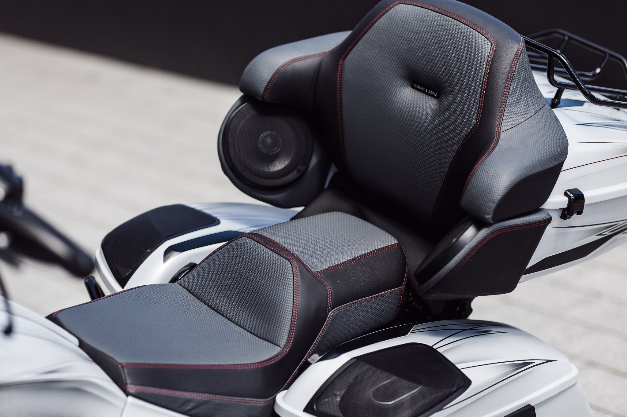 Custom seat with tour pak back rest on a Harley Davidson Road Glide.