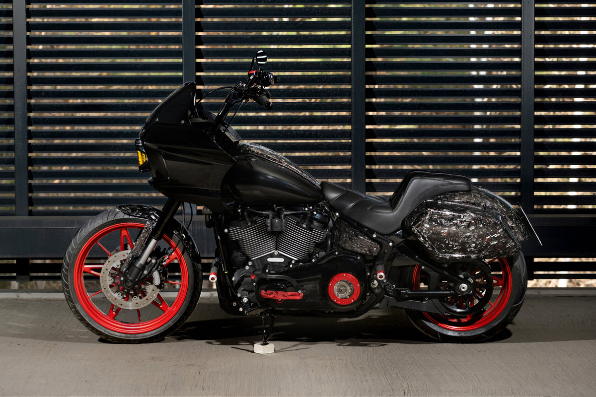 2020 Harley-Davidson Low Rider S FXLRS Forged Sinner V2 with ST fairing, forged carbon fiber saddlebags and red wheels, left side view.