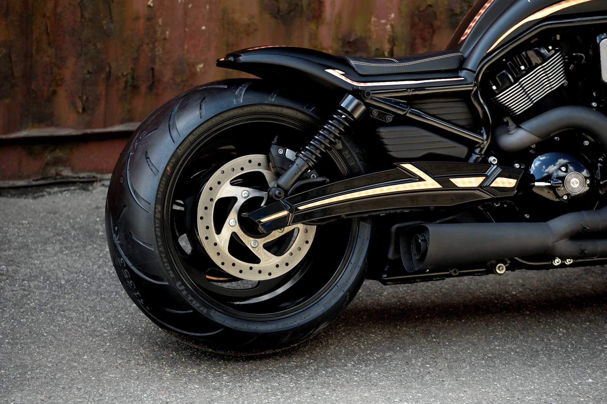 Custom rear fork for a Harley Davidson V-Rod Night Rod painted in black with copper stripes. 