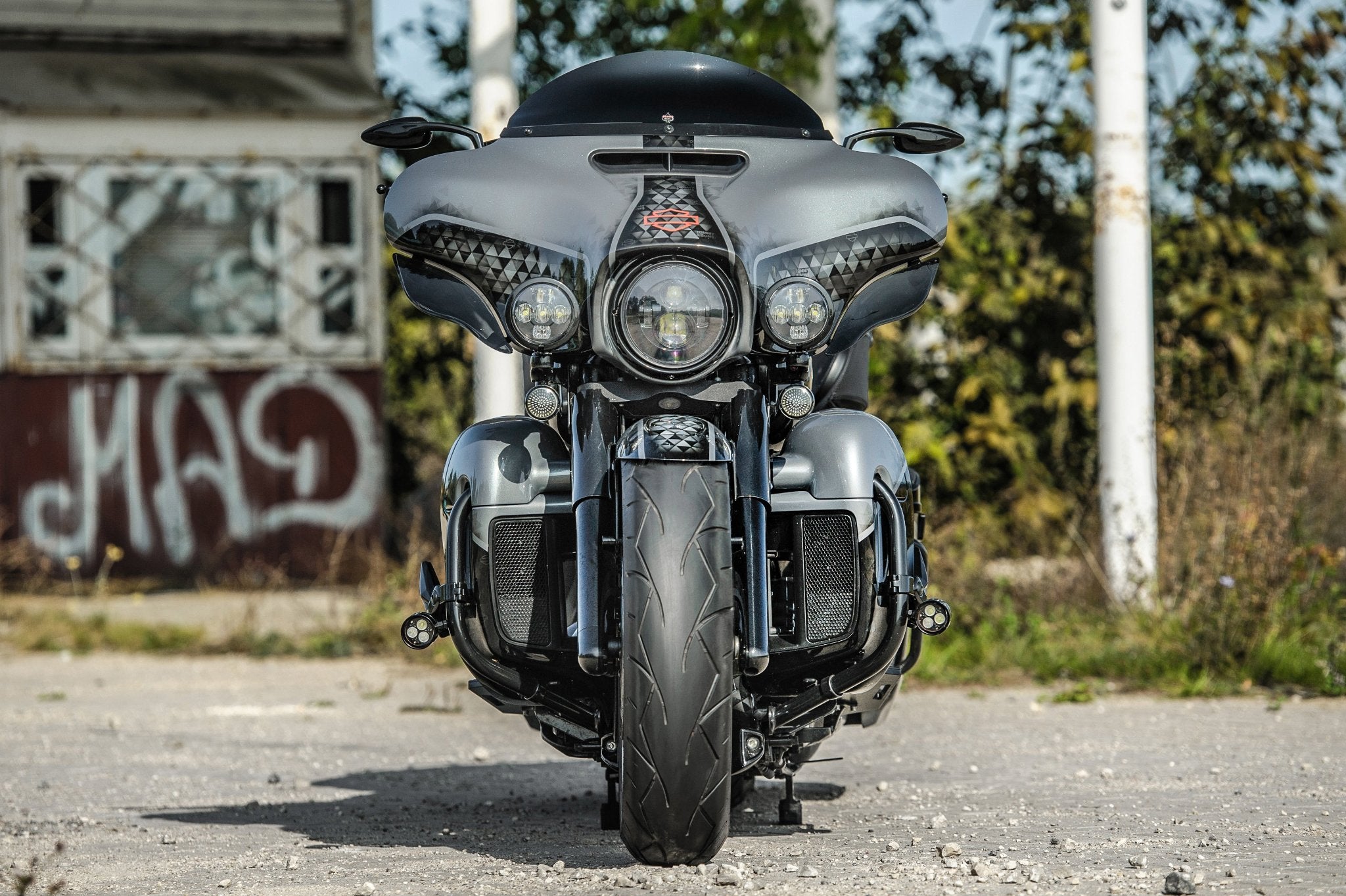 Custom harley davidson street glide with fat front 21" wheel photographed from the front. 