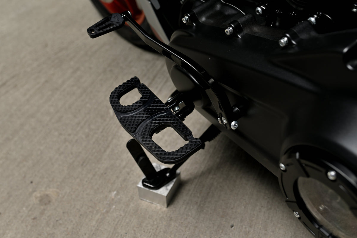 A close-up of a Harley Davidson Low Rider ST foot peg