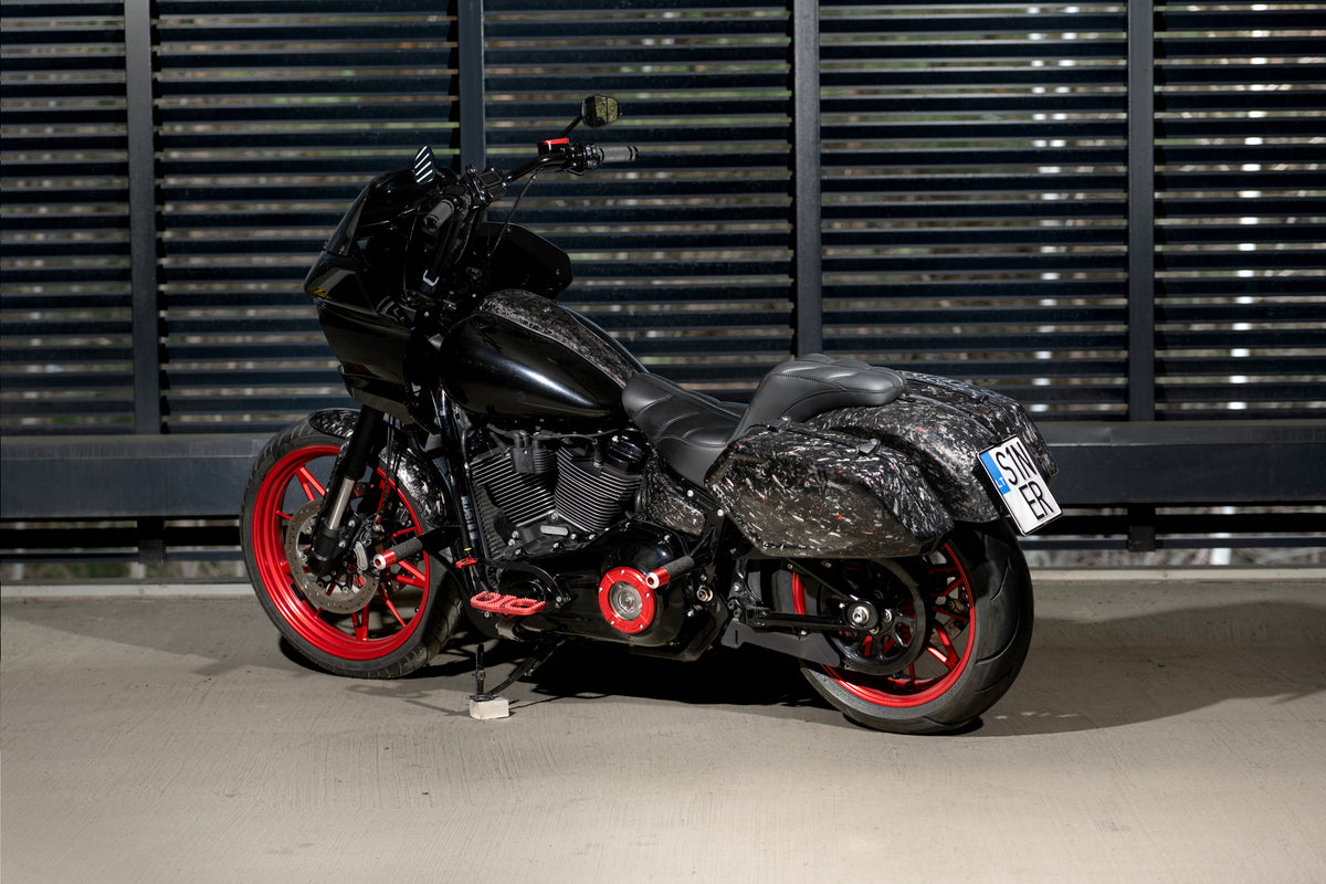 Rear three-quarter view of Forged Sinner V2 showing matching forged carbon fiber saddlebags, rear fender and red rear wheel.