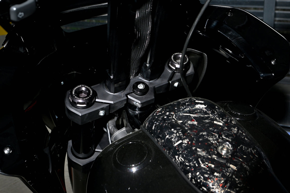 Close-up of the custom triple tree and handlebar risers on Forged Sinner V2 with forged carbon fiber tank console.