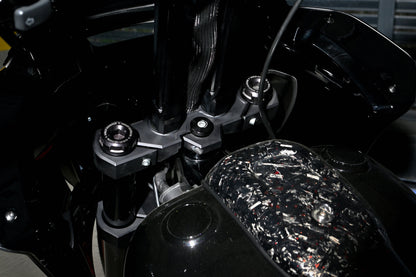 Close-up of the custom triple tree and handlebar risers on Forged Sinner V2 with forged carbon fiber tank console.