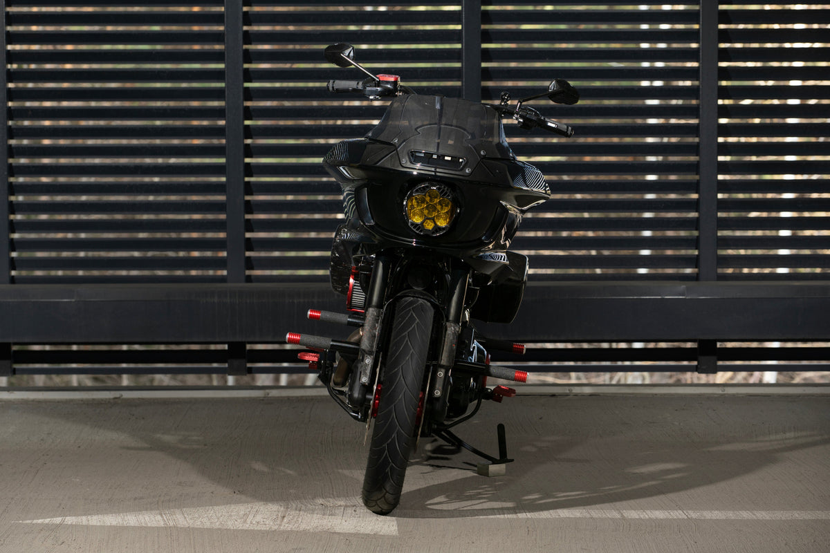 Front view of Forged Sinner V2 showing the Baja Designs yellow LED headlight integrated into the Low Rider ST fairing.