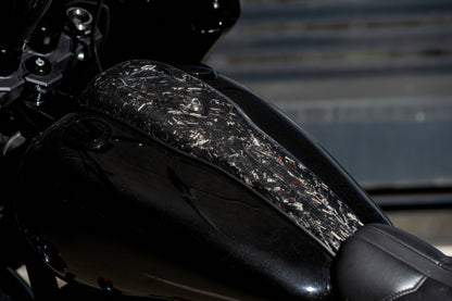 Close-up of custom forged carbon fiber fuel tank console with red flakes on a Harley-Davidson FXLRS.